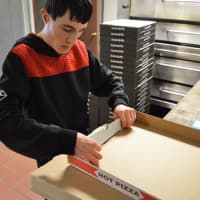 <p>On Tuesday mornings Frank Botti, 20, of ECLC in Ho-Ho-Kus puts together hundreds of pizza boxes.</p>