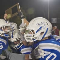 <p>Haldane players hoist the Section 1 Class D championship plaque after beating Tuckahoe Friday at Mahopac.</p>