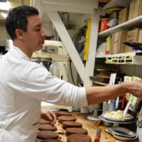 <p>Pastry Chef Scott Casey of New Milford, a U.S. Army veteran who graduated from The Culinary Institute of America, works on Chocolate Oreo Cakes at Reinhold&#x27;s Quality Bakery.</p>