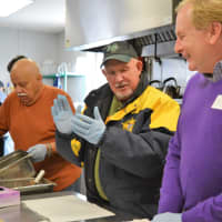 <p>Midland Park Mayor Harry Shortway, flanked by Community Meals volunteers, applauds the team effort during Mayors for Meals.</p>