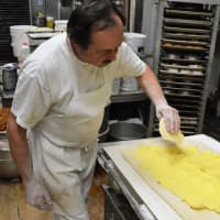 <p>Baker Bill Sidlovsky of West Milford, who started baking in his teens, applies a butter blend as he works on laminating Danish dough.</p>