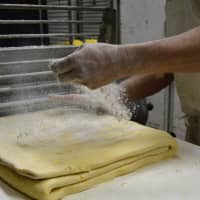 <p>Baker Bill Sidlovsky of West Milford works on laminating Danish dough.</p>