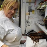 <p>Christine Tominovich of Upper Saddle River dips cookies in chocolate at Reinhold&#x27;s Quality Bakery, opened by her parents, Reinhold and Hanna Gramsch, in 1959.</p>