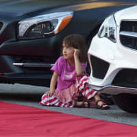 <p>A young girl watches models walk the runway at Wednesday&#x27;s Fashion on the Avenue.</p>