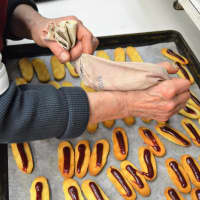 <p>Piping jelly onto cookies at Reinhold&#x27;s Quality Bakery.</p>