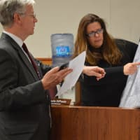 <p>After questioning exactly what territory would be affected by the four-story height change, Emerson Councilwoman Danielle DiPaola looks at a map with Borough Administrator Robert Hoffmann.</p>