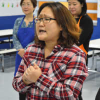 <p>Jenny Hong of the Korean Parents Support Committee delivers heartfelt thanks to the crossing guards of Norwood.</p>