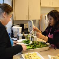 <p>Serving up salad at a brunch honoring crossing guards and support staff in the kitchen at the Norwood Public School.</p>