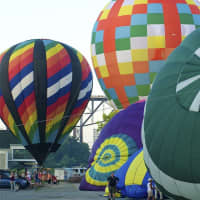 <p>Balloons are inflated prior to a mass launch at the 2013 festival.</p>