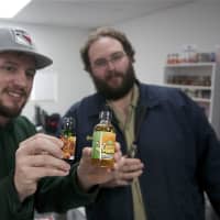 <p>Dave&#x27;s E Cig Shop&#x27;s Scott Martin (R) shows a customer some of the store&#x27;s popular flavors.</p>