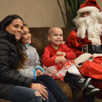 <p>Smiles all around as 4-year-old Alex Hammer enjoys all the attention. Pictured, from the left, are Krista Hammer, Alanna Hammer, Alex Hammer, and Santa.</p>