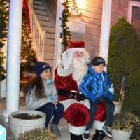 <p>Alanna Hammer and her brother, Alex, enjoy a moment on their front stoop with Santa.</p>