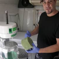 <p>Michael Fertucci turns frozen green tea into a shaved ice treat.</p>