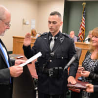 <p>Hillsdale Mayor Douglas Frank swears in Patrolman Corey Rooney as his mother, Patti Rooney, looks on, and his father, Rick Rooney, holds the Bible.</p>