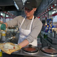 <p>Serving up pizza and fried dough — always a carnival favorite.</p>