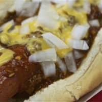 <p>A hot dog smothered in chili, cheese and onions.</p>
