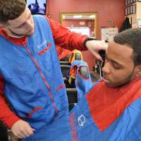 <p>Mike Hogan of Bergenfield puts the finishing touches on a client at Cache Latino in Bergenfield.</p>