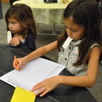 <p>Sisters Samantha Keller, left, and Ainsley Keller, of Ridgewood, were the youngest honey taste testers at the Honey Cup at Ramapo College.</p>