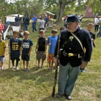 <p>Kids get a lesson on marching with a rifle at the civil war encampment at the Weston Historical Society.</p>