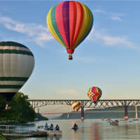 <p>Balloons navigate the Walkway and the Mid-Hudson Bridge during the 2013 festival on the Hudson.</p>