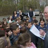 <p>First Selectman Mike Tetreau reads a proclamation to the children at Burr Elementary School.</p>