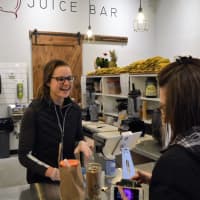 <p>Jessica Piatt helping a customer at the new Beets Juice Bar in Park Ridge.</p>