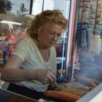 <p>Dolores Santucci works the hot dog stand at Karl Ehmer’s Quality Meats in downtown Hillsdale.</p>