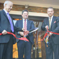 <p>Sideras, joined by the mayor and his father, cuts the ribbon on the River Edge Diner.</p>