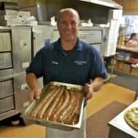 <p>Manager Patsy Femia shows off some of the restaurant&#x27;s freshly made sausage.</p>