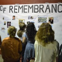 <p>A steady stream of people at the Wall of Remembrance.</p>