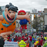 <p>Fred Flintstone greets the crowd at the Stamford Parade.</p>