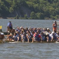 <p>Teams push toward the finish line of the 200-meter course on the Hudson River.</p>