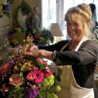 <p>Annabel Green Flowers owner Wendy Manes prepares arrangements for Mother&#x27;s Day in her Wilton shop.</p>