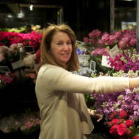<p>Owner Sandra Nielsen-Baumann works with flowers in the cooler at Nielsen&#x27;s Florist &amp; Garden Shop in Darien.</p>