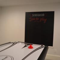 <p>A new air hockey table and scoreboard are among the new toys for Talia and her siblings in the basement.</p>