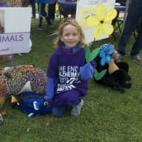 <p>A girl with stuffed animals available at the Walk to End Alzheimer&#x27;s.</p>