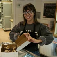 <p>A worker boxes some goodies from the Riviera Bakehouse.</p>