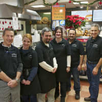 <p>Brothers Lenny and Steve Sauro flank staff at Sauro&#x27;s Gourmet Deli &amp; Catering.</p>