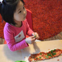<p>Ripping and placing spinach helps children learn fresh food can be easy to prepare and delicious to eat.</p>