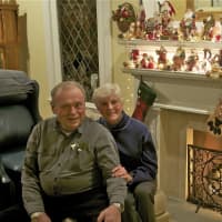 <p>Ed and Lenore Lundberg sit next to their Santa collection - one of many holiday traditions that keeps the holiday spirit flowing.</p>