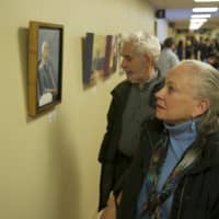 <p>Guests look at some of the new art at the hospital at Friday night&#x27;s reception.</p>