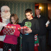 <p>Melissa and Matthew unwrap new iPads from Santa Boone -- Ex-Detective David Boone. Mayor John Cosgrove looks on from behind.</p>
