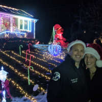 <p>Joe and Dawn Fortis in front of their Fairfax Road display. The couple recently started giving donated funds to a children&#x27;s cancer hospital.</p>