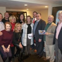 <p>Putnam County Executive MaryEllen Odell (center) hosted a holiday party Thursday evening at Putnam County Golf Course, with donations going to United for the Troops, run by Jim Rathschmidt (holding card).</p>