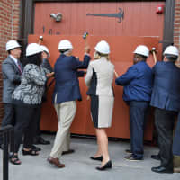 <p>Hackensack officials take a ceremonial swing at the old Masonic Lodge on State Street. Its transformation into a new performing arts center has begun.</p>