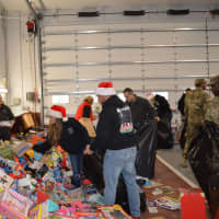 <p>Sorting through mountains of toys at the Closter firehouse.</p>