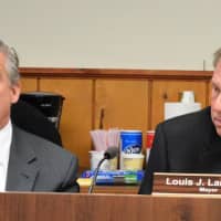 <p>Emerson Planning Attorney Doug Doyle answers a question as Mayor Lou Lamatina looks on.</p>