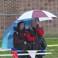 <p>Spectators stay dry at Friday&#x27;s meet.</p>