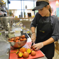 <p>Jessica cutting golden beets at Super Juice Nation.</p>