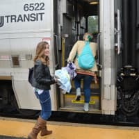 <p>A relaxed Francina Alvarez boards a train for a night pleasure trip into New York City in contrast to her more frazzled morning commute.</p>
